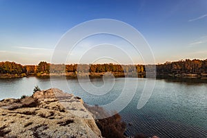 Calm autumn lake in the evening at sunset