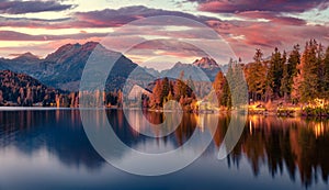 Calm autumn sunset on Strbske pleso lake.