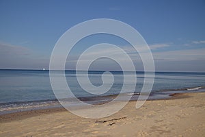 calm Baltic Sea after the storm - thrown stones and sea of amber