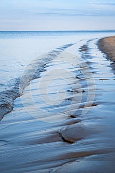 Calm Baltic Sea during sunny day with blue sky and some clouds near Carnikava, Latvia