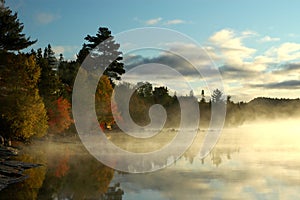 Calm bay at sunrise over beautiful lake