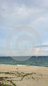 Calm beach scenery and a rainbow at Besar Island in Mersing, Johor, Malaysia photo