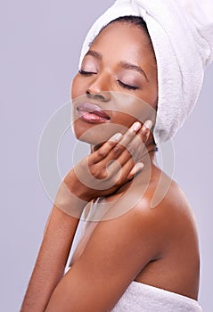 Calm, black woman or hair towel in studio with skincare, wellness or beauty on purple background. Makeup, cleaning or