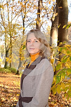 Calm blonde woman in fall park