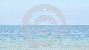 Calm blue sea ocean with the horizon on the beach and clear sky and white sand background. Beautiful nature and landscape concept