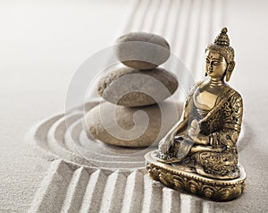 Calm Buddha and balancing stones in sand lines and