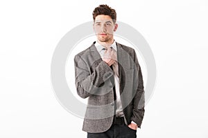 Calm business man in jacket with arm in pocket