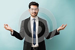 Calm Businessman Performing Meditation In Studio