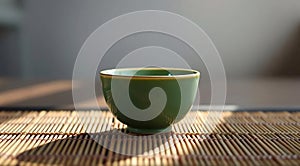 Single Green Tea Cup on Bamboo Mat