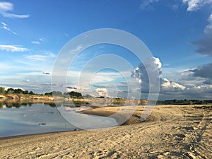 Calm countyside river with a sandy coast