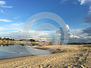 Calm countyside river with a sandy coast photo