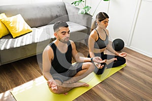 Calm couple relaxing with yoga