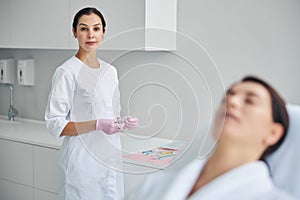 Calm dermatologist ready for treating her patient