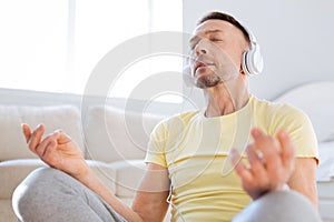 Calm determined man immersing in meditation