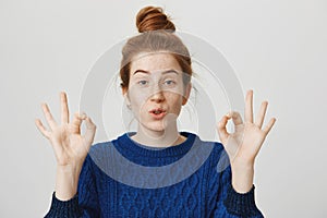 Calm down, I got this, rely on me. Studio portrait of confident attractive woman with ginger hair color and freckles