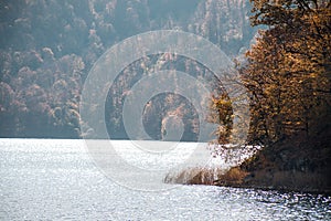 A calm evening landscape with lake and mountains. Amazing view of the Goy-Gol (Blue Lake) Lake among colorful fall forest at Ganja