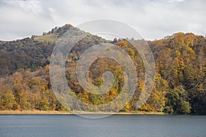 A calm evening landscape with lake and mountains. Amazing view of the Goy-Gol (Blue Lake) Lake among colorful fall forest at Ganja