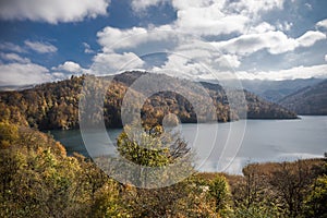 A calm evening landscape with lake and mountains. Amazing view of the Goy-Gol (Blue Lake) Lake among colorful fall forest at Ganja