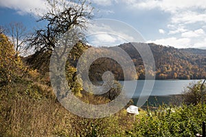 A calm evening landscape with lake and mountains. Amazing view of the Goy-Gol (Blue Lake) Lake among colorful fall forest at Ganja