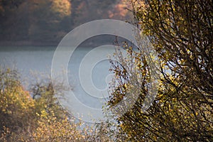 A calm evening landscape with lake and mountains. Amazing view of the Goy-Gol (Blue Lake) Lake among colorful fall forest at Ganja