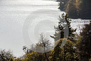 A calm evening landscape with lake and mountains. Amazing view of the Goy-Gol (Blue Lake) Lake among colorful fall forest at Ganja