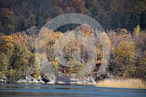 A calm evening landscape with lake and mountains. Amazing view of the Goy-Gol (Blue Lake) Lake among colorful fall forest at Ganja