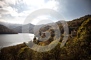 A calm evening landscape with lake and mountains. Amazing view of the Goy-Gol (Blue Lake) Lake among colorful fall forest at Ganja