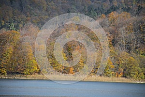 A calm evening landscape with lake and mountains. Amazing view of the Goy-Gol (Blue Lake) Lake among colorful fall forest at Ganja