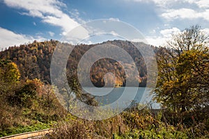 A calm evening landscape with lake and mountains. Amazing view of the Goy-Gol (Blue Lake) Lake among colorful fall forest at Ganja