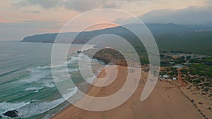 Calm evening seascape aerial view. Twilight cloudy sky over picturesque beach