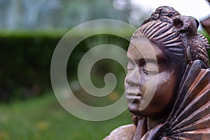 Calm face of a woman statue in a graden. Buddhism and peace concept