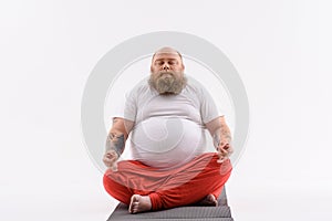 Calm fat guy doing yoga