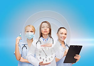 Calm female doctor and nurses with wall clock