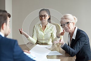 Calm female employee meditate at meeting avoiding conflicts