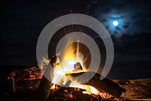 Calm fire on the beach under moon light.