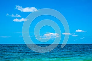 Calm flat surface of sea and cloudless clear blue sky at horizon