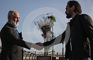 Calm friends shacking their hands stock photo