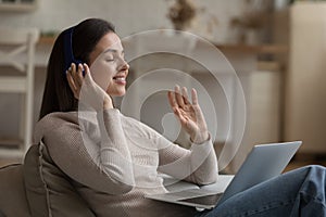 Calm girl in headphones listening to ambient tranquil music