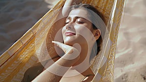 Calm girl lying hammock in sunlight closeup. Carefree beautiful woman relaxing