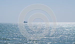 Calm glittering sea and cloudless sky photo