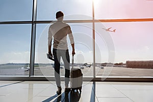 Calm guy looking at flying plane