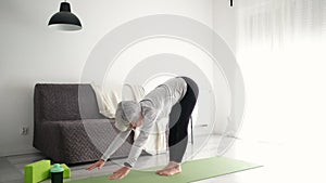 Calm And Happy Senior Woman Doing Yoga At Home