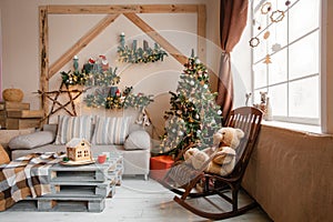 Calm image of interior modern home living room decorated christmas tree and gifts, sofa, table covered with blanket.