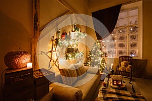 Calm image of interior modern home living room decorated christmas tree and gifts, sofa, table covered with blanket.