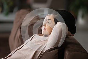 Calm Indian woman relax on couch sleeping