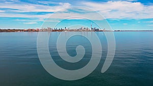 Calm lake, clear day, urban landscape backdrop, health focus. Health reflected serene, clear skies, city view. Urban