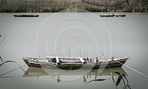 Calm lake with fishing boats. Fresh water lagoon in Estany de cullera. Valencia, Spain