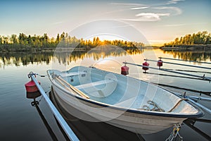 Calm Lake with Reeds at Sunrise, Fishing Boat Tied to Wooden Pier
