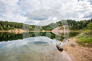 Calm lake with reflections of clouds in summer