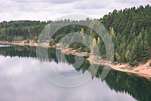 calm lake with reflections of clouds in summer- vintage retro l